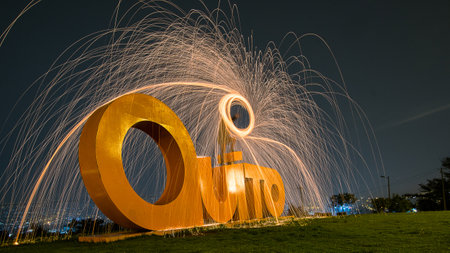 Monument with the name of the city of Quito and flashes of lights and colors above