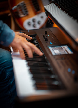 A vertical picture of a male playing on the pianoの写真素材