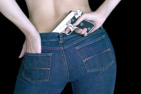 A closeup shot of female holding a gunの写真素材
