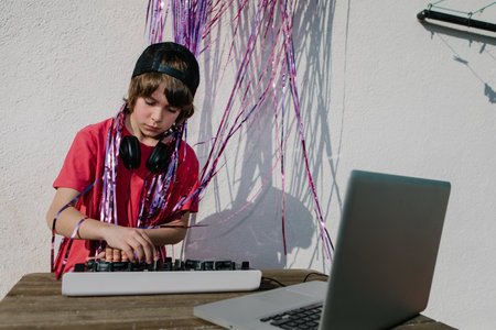 A young American boy near the DJ controller - the concept of DJing