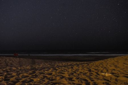 A beautiful shot of sandy beach under the starry skyの写真素材