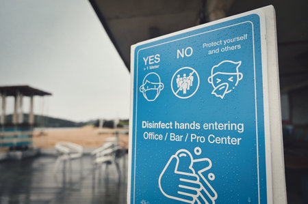 A close up shot of a pandemic prevention sign in an empty beach bar in Italyの写真素材