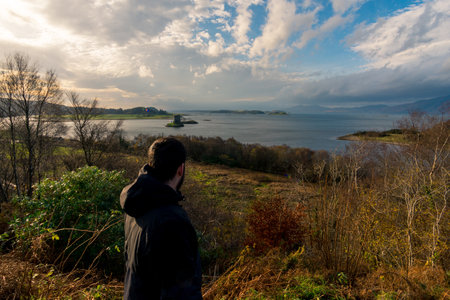 An explorer looking the views to loch ness from Urquhart castle