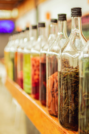 The bottles of macerated herbs and ingredients for making alcoholic beveragesの写真素材