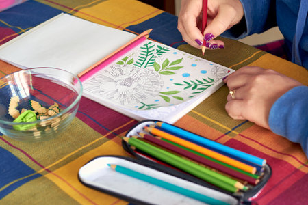 A female painting mandalas to combat stress caused by confinement to prevent coronavirus COVID-19の写真素材