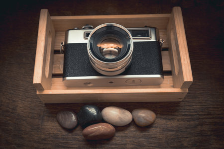 A high angle closeup shot of a vintage camera in a locker under the light