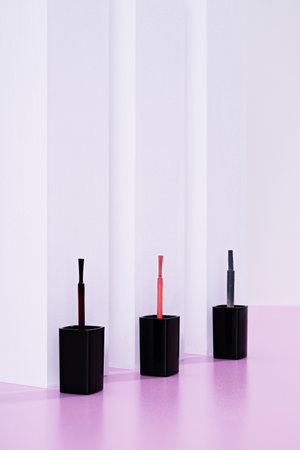 A vertical  shot of nail polish brushes against a white backgroundの写真素材