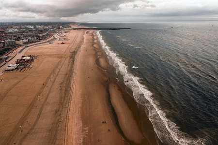 An aerial shot Scheveningen beach located near the Hague city in the Netherlands on a gloomy dayの写真素材