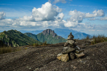 A beautiful view of a pile of rocks on the hill with mountains on the backgroundの写真素材