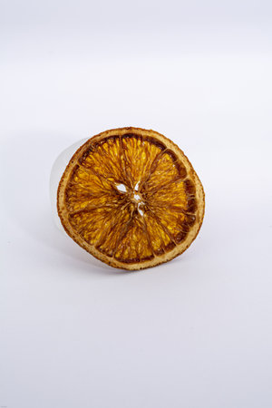 A closeup shot of a dried orange slice isolated on white backgroundの写真素材