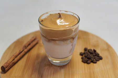 dalgona iced coffe close up with some decotarion over a bamboo plateの写真素材