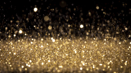 A closeup shot of glittering gold dust on a black backgroundの写真素材