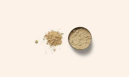 An overhead shot of ginger powder in a white ceramic bowl on a white backgroundの写真素材