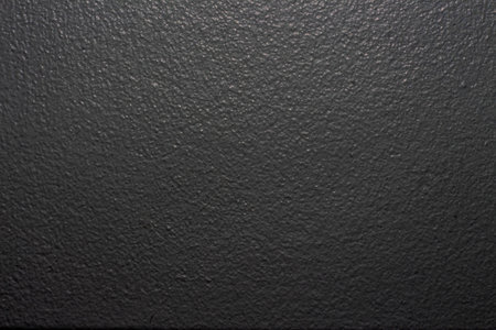 A closeup shot of a black rough wall surface