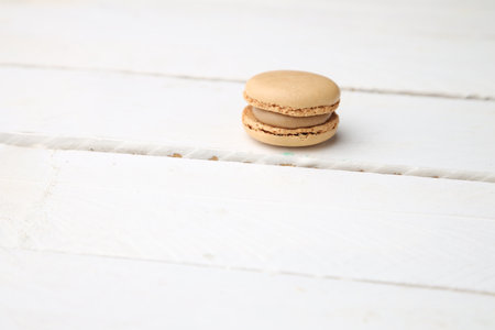 The sweet and  delicious brown macaroon cookies on the wooden surfaceの写真素材
