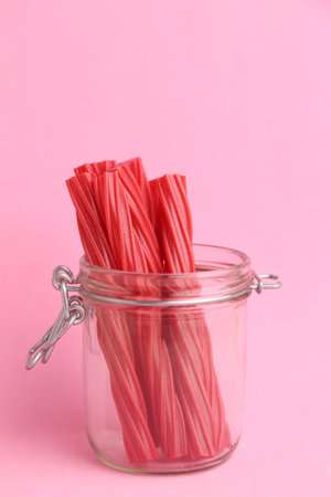 A closeup shot of sweet red gummy licorice in color backgroundの写真素材