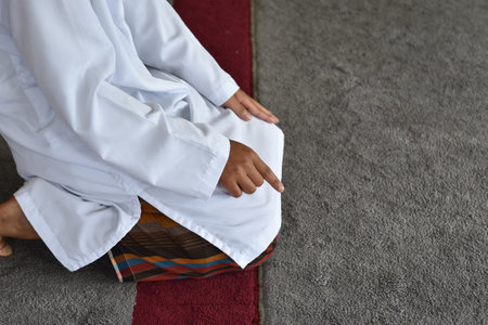 Muslim men praying in Tashahhud posture. Islamic conceptの写真素材