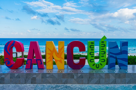 A closeup shot of the colorful word Cancun on the seashore on a bright day in Mexicoの写真素材