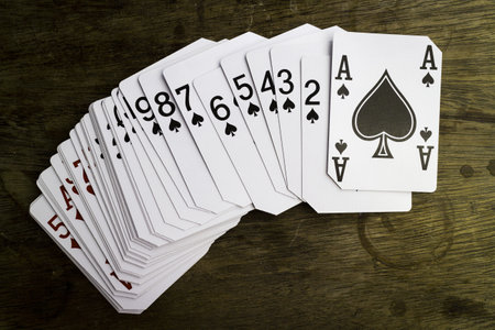 A top view of playing cards on a wooden surface