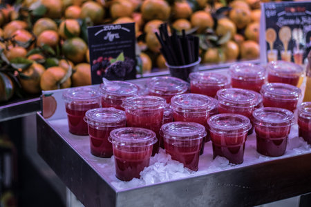 A closeup shot of small strawberry juice in a plastic cups