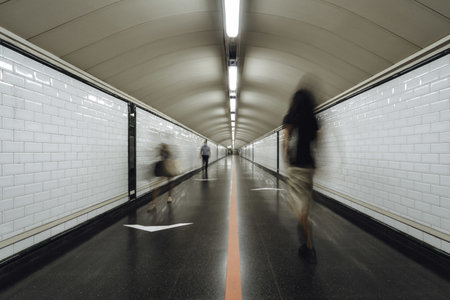 A group of people rushing through a subway corridorの写真素材