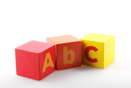 A closeup of wooden alphabet blocks isolated on a white backgroundの写真素材