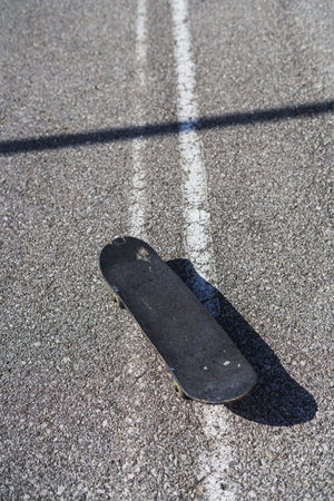 A vertical shot of skateboard in the roadの写真素材