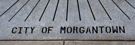 A high angle shot of 'City of Morgantown' on a concrete street grate in downtown Morgantown, WVの写真素材