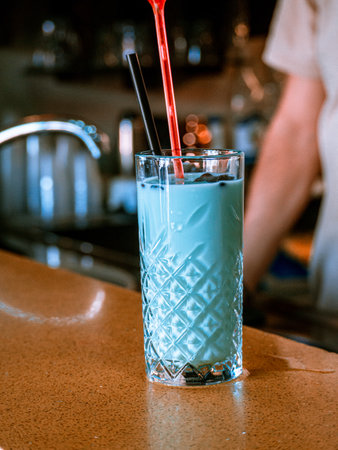 A vertical shot of a mint cocktail at a barの写真素材