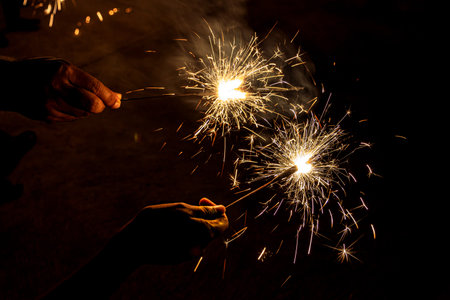 Womens celebrating Indian festival diwali with fire crackers.