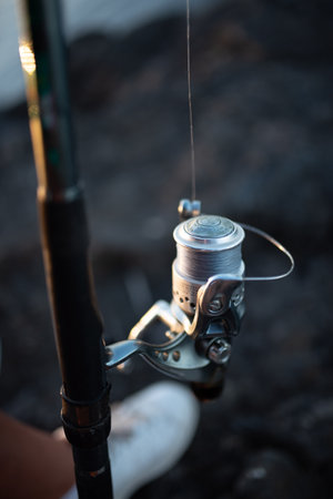 A vertical closeup shot of a fishing reelの写真素材