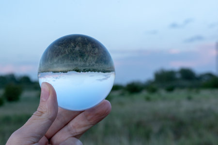 A beautiful shot of a field through a glass ballの写真素材