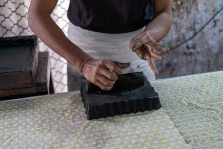 A closeup shot of a person doing handblock printingの写真素材
