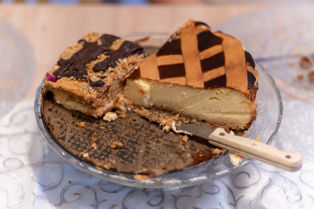 A selective focus shot of a knife and pieces of cakes on a plate on the table
