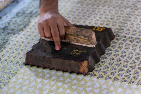 A closeup shot of a person doing handblock printing