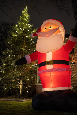 A vertical shot of Christmas lighting and Christmas decoration with a funny dancing Santaの写真素材