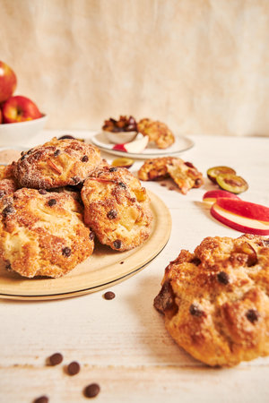 A vertical closeup shot of delicious baked apple curd balls on a table with ingredientsの写真素材