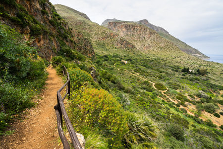 The coastline trail overlooking the Mediterranean sea at Zingaro Nature Reserve, San Vito Lo Capo, Sicily, Italyの写真素材