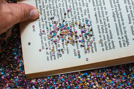 A closeup shot of a book page sprinkled with glittersの写真素材