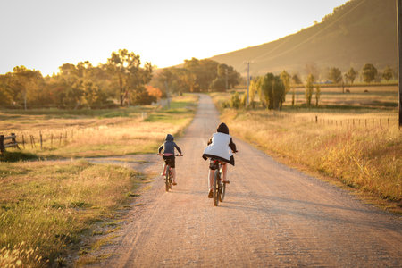The children riding bikes on a remote country laneの写真素材