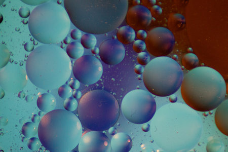 A macro shot of colorful bubbles on a dark background - perfect for wallpapers or backgroundの写真素材
