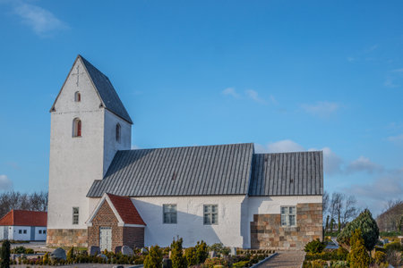 The Sonder Nissum Church under a blue sky and sunlight in Ulfborg, Denmarkの写真素材