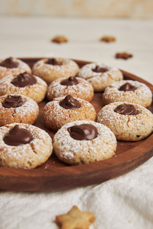 A vertical shot of delicious Christmas cookies with chocolate on a white table