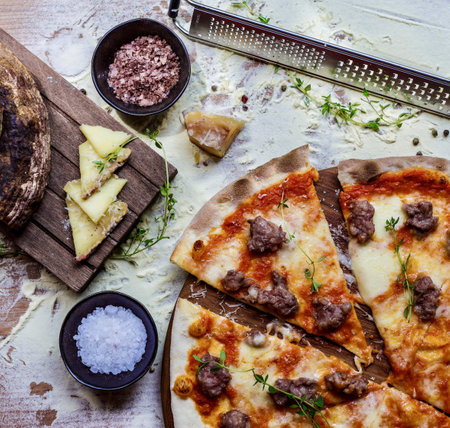 A top view of a homemade delicious pizza on a kitchen tableの写真素材