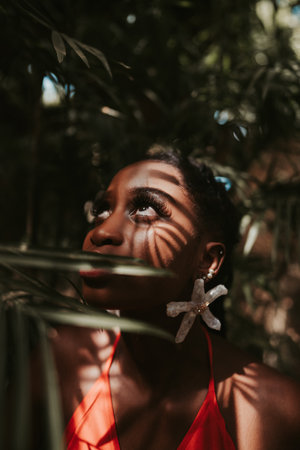 A shallow focus shot of an attractive African -American female with dreadlocks posing at cameraの写真素材