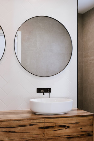 The beautiful modern style black faucet with ceramic sink in the bathroomの写真素材