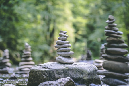 A majestic shot of many stone pyramids balanced on a river water