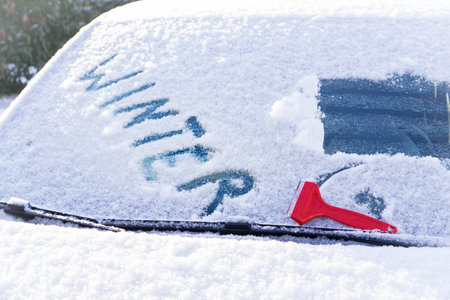 A closeup shot of the word winter on a snow windshieldの写真素材