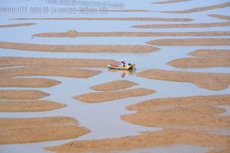 A shot of a boat in the river, a unique landscape after ebb-tideの写真素材