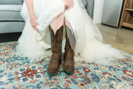 A bride in her cowboy boots for a country weddingの写真素材
